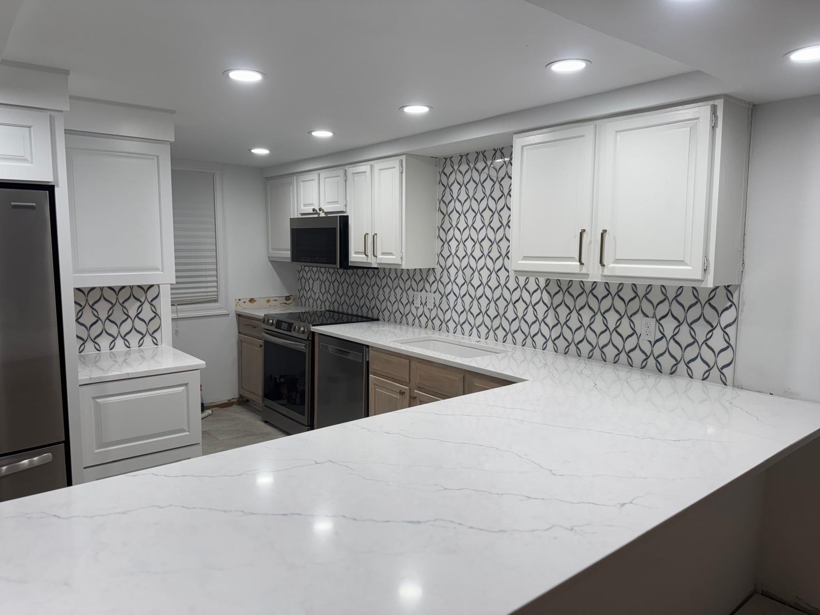 Open-concept kitchen with patterned backsplash